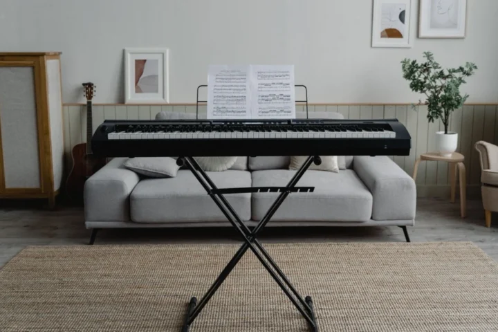 Digital piano on an X-style stand in a furnished living room